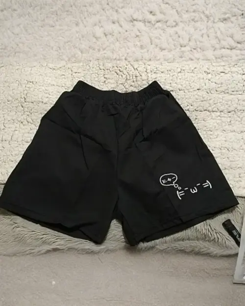 Black cotton shorts with kaomoji aesthetic print.