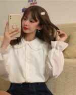 Woman wearing a white vintage aesthetic shirt with a French Style Collar.