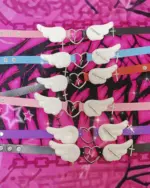 Collection of winged heart necklaces in various colors and designs, featuring a Harajuku aesthetic.