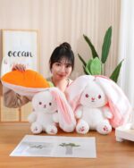 Kawaii transformable bunny plushie featuring a white bunny and strawberry, with carrot accessories.