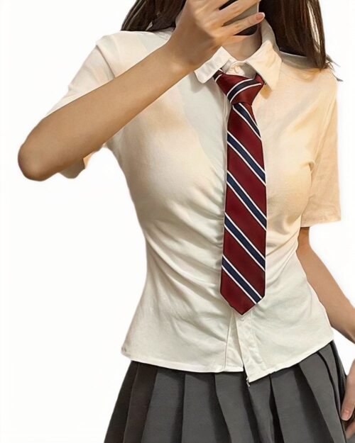 Woman wearing a Summer Uniform Set - Preppy Aesthetic, featuring a short-sleeved shirt and striped tie.