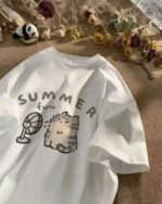 Neko Adventures kawaii cat t-shirt featuring a summer illustration with a fan and cat.