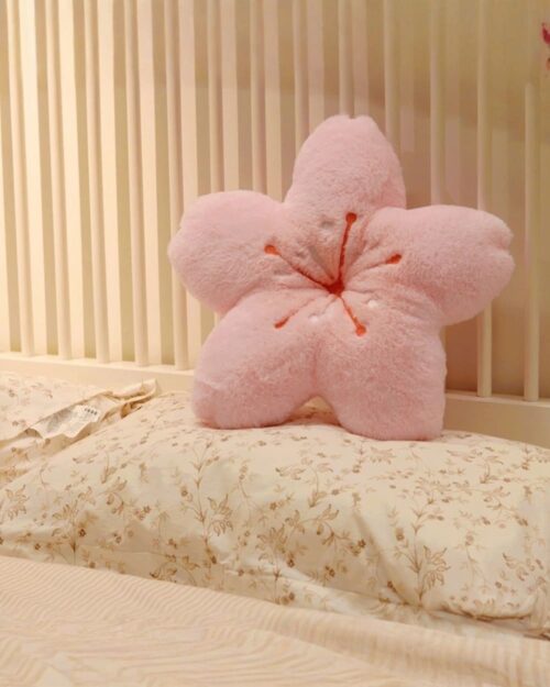 Pink cherry blossom pillow, kawaii decor, plush flower cushion on bedding.