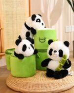 Several panda bamboo plushies are nestled among green cylinders, showcasing the Pocket Panda Plush - Bamboo Edition.