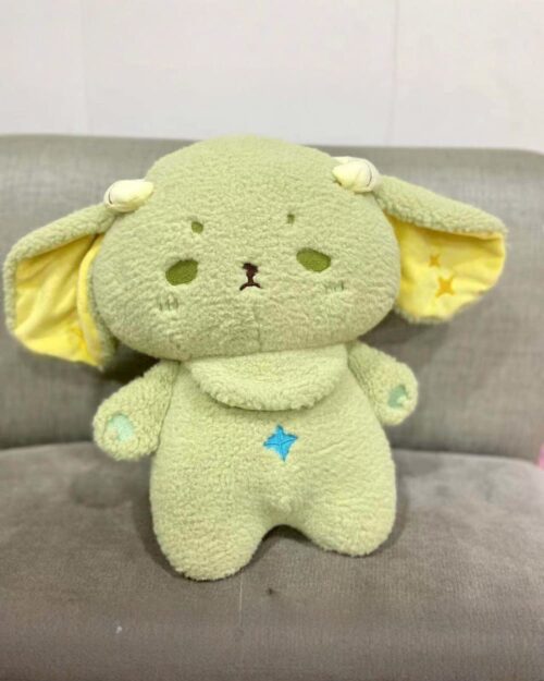 A green kawaii space sheep plushie with large ears and embroidered details.