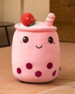 Pink boba milk tea plush toy with fruit accents and bubble details.