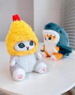 Chibi shark cat plushie sitting on a shelf with another plushie.