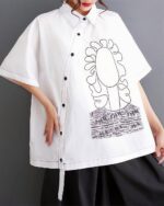 White retro aesthetic shirt with floral and graphic embroidery details.