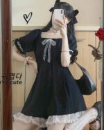 Black waist puffy dress with ruffled details and a bow, dark kawaii aesthetic.