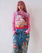 Pink y2k animecore shirt with anime graphic, layered over distressed denim jeans.