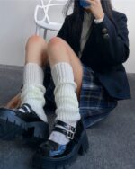 White japanese gyaru socks worn with platform boots and plaid skirt.