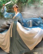 A woman wearing a jade ruqun hanfu long dress, blue and white, outdoors.