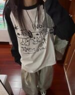 White dog doodle t-shirt with black accents, long sleeve.