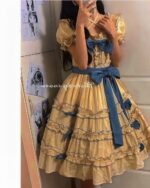 Yellow french lolita dress with ruffles, bow, and blue ribbon details.