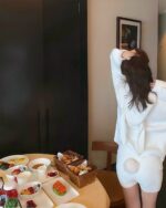 Woman wearing fluffy bunny pajamas, soft girl aesthetic, lounging with breakfast.