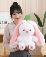 Kawaii transformable bunny plushie with pink ears and a carrot accessory, soft and cuddly.