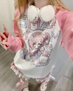 Pink kawaii t-shirt featuring anime-style illustration with headphones and ruffles.