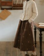 Brown embroidered retro aesthetic skirt with floral details, worn by a child.