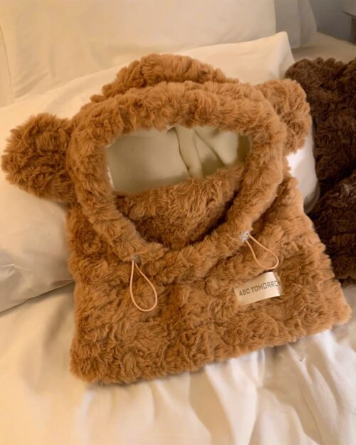 Brown fluffy bear ear hat with attached ear details and a loop.