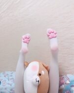 Pink cat paw socks on a plush toy foot, showcasing cat paw socks.