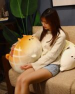 A Melonwan dog plushie, a cute, soft, and cuddly kawaii toy, resting on a couch.
