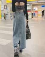 Long y2k denim skirt with a high-low design and open back detail.