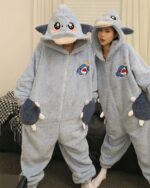 Two people wearing a blue dino-shark jumpsuit, couple edition, plush onesie.