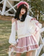 White lolita aesthetic sweater with off-shoulder design, heart embroidery, and pink skirt.