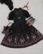Black gothic lolita dress featuring a celestial print and coffin motifs, paired with accessories.