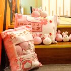 A large snack bag plushies set with pink bunny figures, displayed on a decorative pillow.