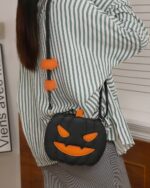 Cute black pumpkin halloween bag with orange accents and handles.
