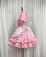Pink Japanese maid dress with ruffles and lace details, kawaii aesthetic.
