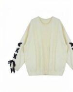 Cream-colored Korean aesthetic sweater with cable knit detailing and bow sleeves.