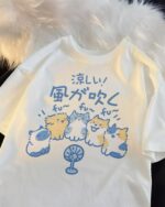 The Wind Blows Cool cat and dog tee – white shirt with blue cartoon cats and dogs design.