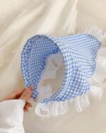 Retro triangle headscarf in blue and white gingham, featuring ruffled edges.