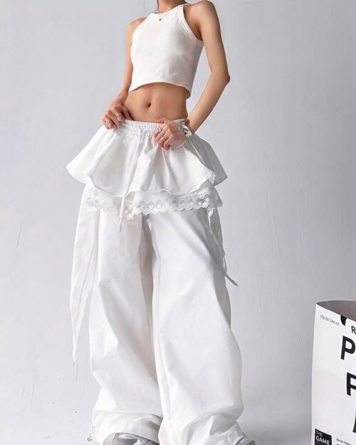 White y2k cargo pants with a ruffled skirt and lace details, worn by a model.