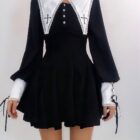 Black gothic nun dress with white lace collar and cuffs, featuring a high neck and button closure.