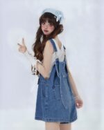 Blue kawaii denim overalls worn by a model with a headband.