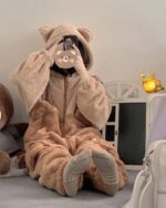 Person wearing brown bear fluffy pajamas, a cozy kawaii outfit.