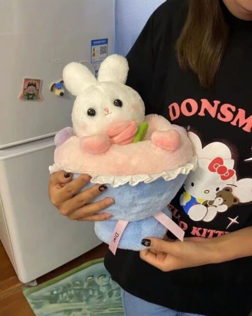 A pink bouquet rabbit plushie held by a person's hands.