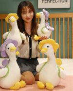 Kawaii Molly the Little Flower Duck plushie toy with floral accents, held by a person.