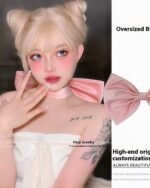 Pink coquette bow choker worn by a model.