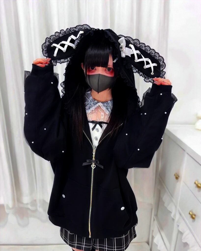 Black rabbit eared cardigan hoodie with lace details and zipper.