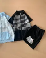 Japanese striped loungewear set consisting of a zip-up jacket and shorts with kawaii cat graphics.