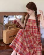 Red and white plaid french vintage suspender skirt, featuring straps and a gathered skirt.