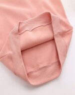 Close-up of a pink neko pullover hoodie collar and cuffs.