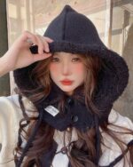 Woman wearing a black korean balaclava hat with a hood.