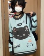 Mint Neko sweater featuring a black cat graphic and kawaii details.