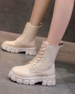 Cream-colored gothic over knee boots, lace-up style with chunky sole.