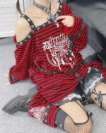 Detailed punk lolita set featuring a striped long-sleeve top with hardware and lace trim, paired with stockings.